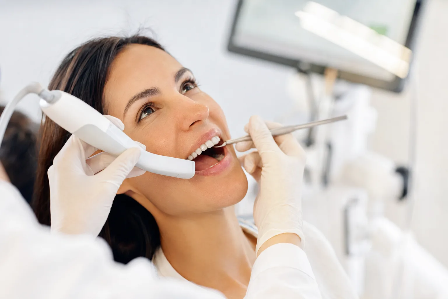 Gentle, skilled hands performing a careful procedure with modern dental tools in soft natural light